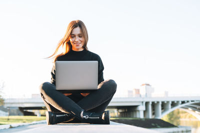 Young woman using laptop at table