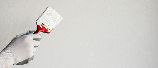 Low angle view of american flag against wall