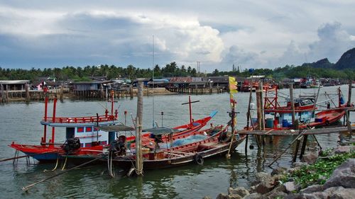 Boats moored in sea against sky