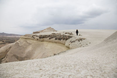 Woman walking on desert