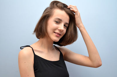 Portrait of smiling girl against white background