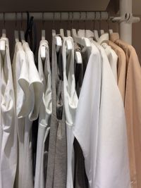 Various clothes hanging on rack