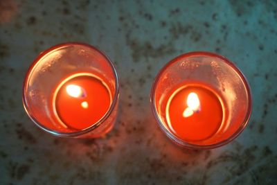 High angle view of illuminated candles on table