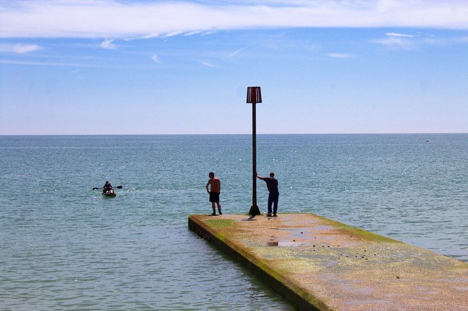 water, sea, real people, leisure activity, men, nature, horizon over water, sky, scenics, outdoors, beauty in nature, day, lifestyles, togetherness, sport, standing, full length, friendship, adult, people