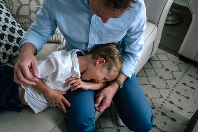 High angle view of mother and daughter sitting on floor