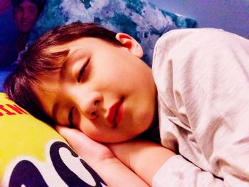 Portrait of cute boy sleeping on bed