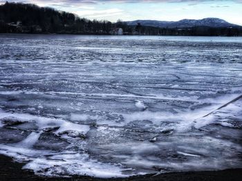 Scenic view of frozen lake against sky