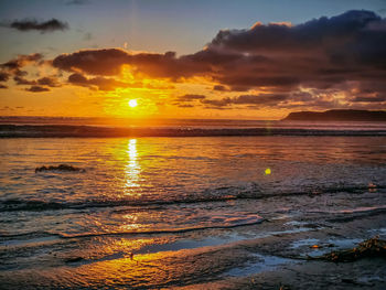 Scenic view of sea against romantic sky at sunset