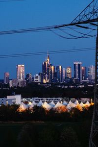 Illuminated buildings against sky in city