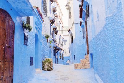 Alley amidst buildings during winter