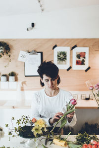 Florist working at table in flower shop