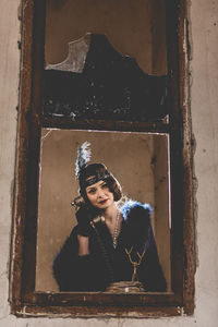 Portrait of beautiful woman standing against wall