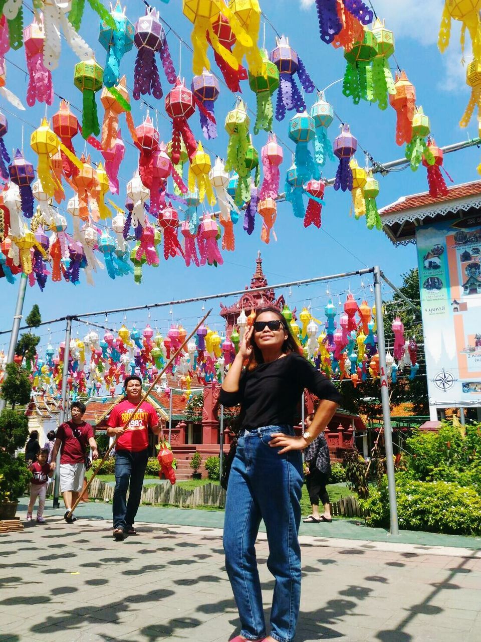 hanging, full length, rear view, childhood, multi colored, art and craft, lantern, lifestyles, ceiling, decoration, in a row, large group of objects, day, outdoors, arch, creativity, culture, colorful