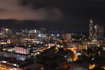 High angle view of illuminated buildings against sky at night