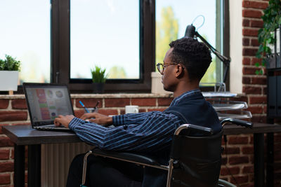 Side view of businessman working in office