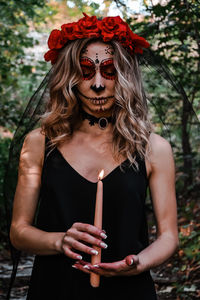 Midsection of woman standing against plants