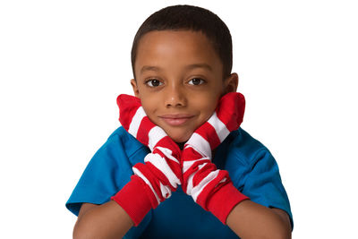 Portrait of boy standing against white background