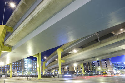 Low angle view of illuminated street lights at night