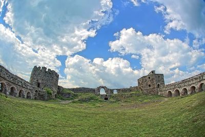 View of abandoned building against cloudy sky