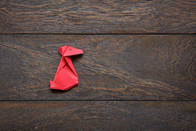 Close-up of red origami on wood