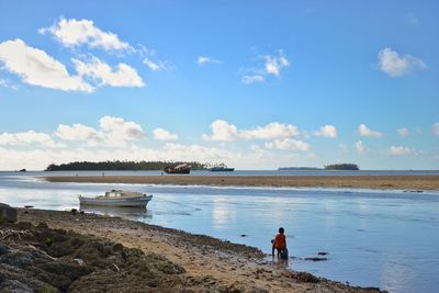 Man standing on beach against sky