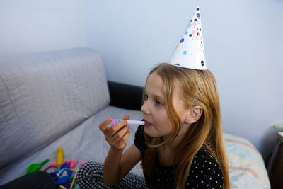 Children have fun playing, blowing up colorful balloons, at a birthday party