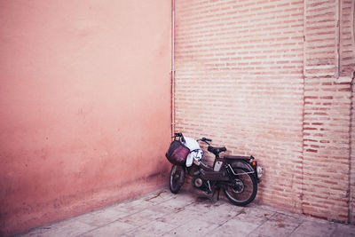 Bicycle parked against wall in building