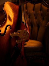 Close-up of violin against armchair