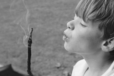 Portrait of cute boy with burning stick