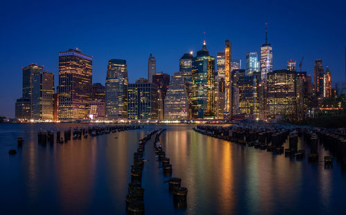 Panoramic view of river and illuminated buildings against sky at night