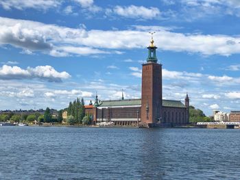 River by buildings against sky in city