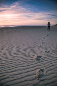 Person walking on sand dune in desert