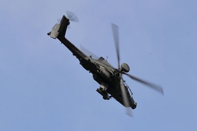 Low angle view of helicopter flying against sky