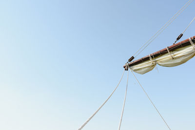 Low angle view of sailboat against clear sky