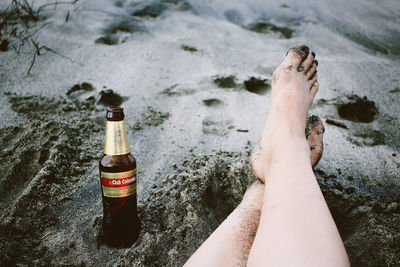 Low section of woman relaxing on beach