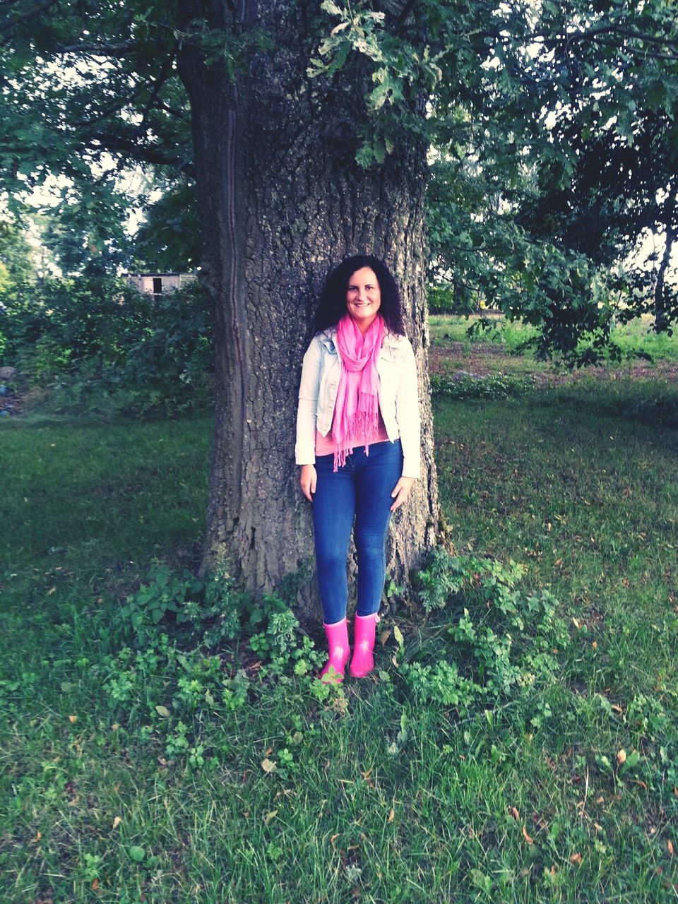 person, young adult, casual clothing, looking at camera, portrait, young women, lifestyles, front view, standing, tree, leisure activity, smiling, grass, full length, long hair, happiness, park - man made space