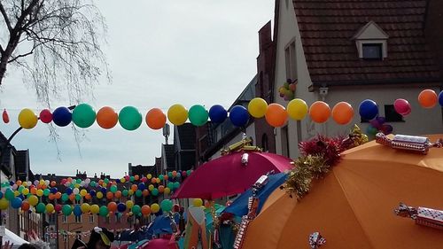 Multi colored balloons against sky