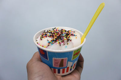 Close-up of hand holding ice cream