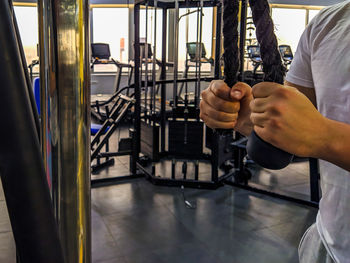 Midsection of man exercising in gym