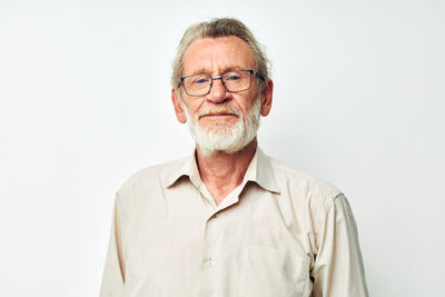 Portrait of man standing against white background