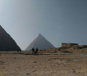 Panoramic view of people on mountain against sky