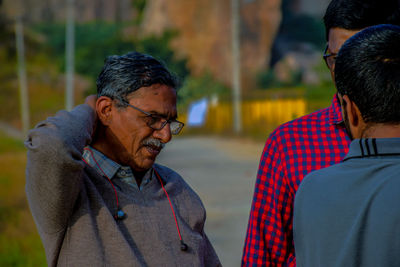 Close-up of people having discussion while standing on road