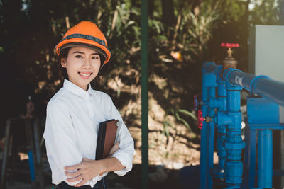 Portrait of woman wearing hardhat