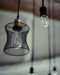 Close-up of light bulb hanging on table