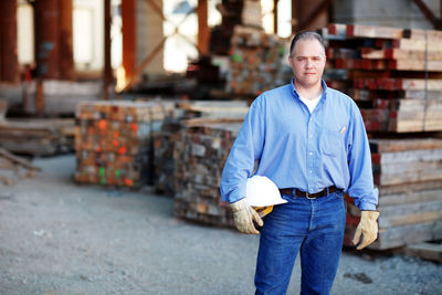 Portrait of a male construction foreman holding a hard hat