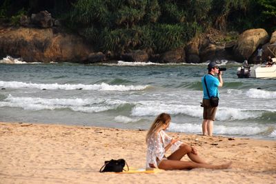 People on beach by sea