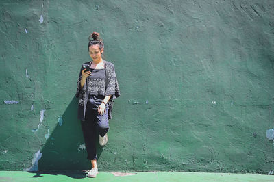 Series photo of happy young women in enjoying emotion with green background of real cement wall