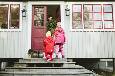 Girls in front of house