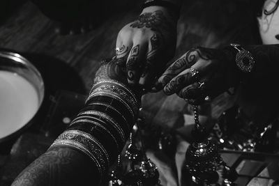 Cropped hands of woman with bride during wedding ceremony 