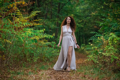 Woman standing in a forest